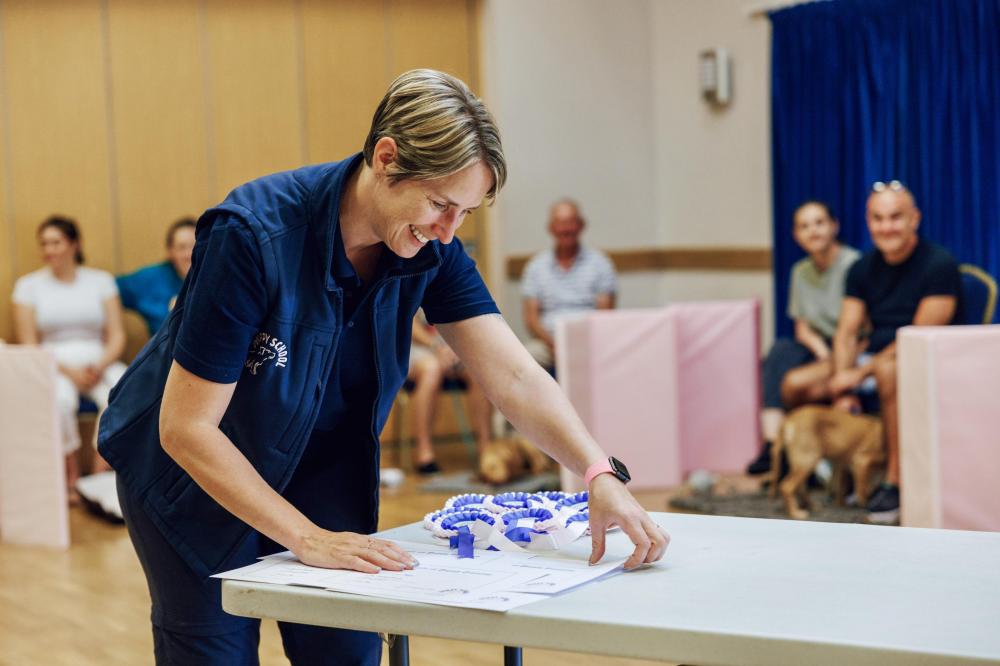 Our tutor preparing rosettes for successful puppies